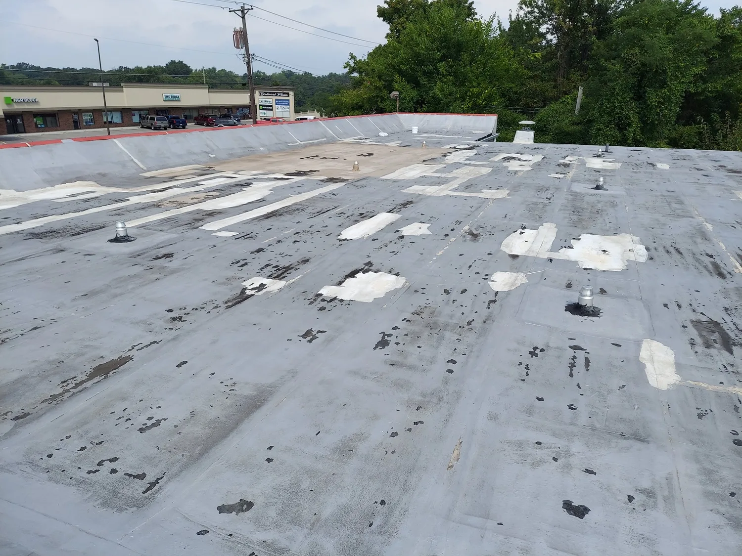 Before and after comparison of a commercial roof coating restoration